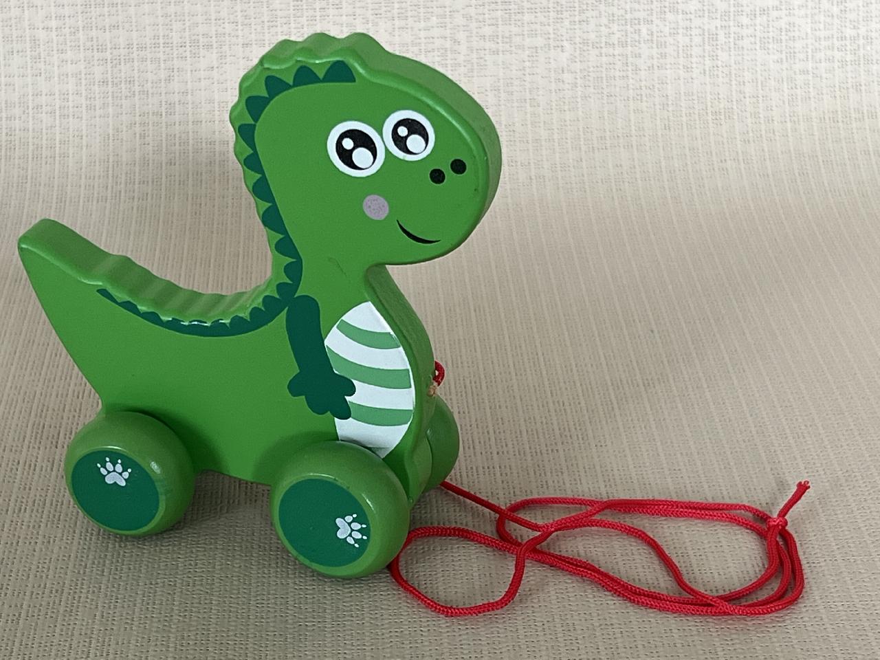 Tahací dřevěná hračka - dinosaurus na kolečkách malý